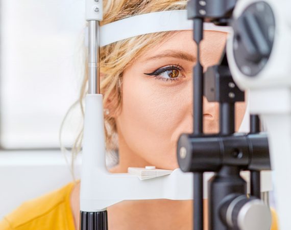 Laser vision correction. A patient and team of surgeons in the operating room during ophthalmic surgery. Eyelid speculum. Lasik treatment. Patient under sterile cover