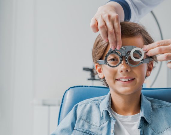 Ophthalmologist examining young woman in clinic